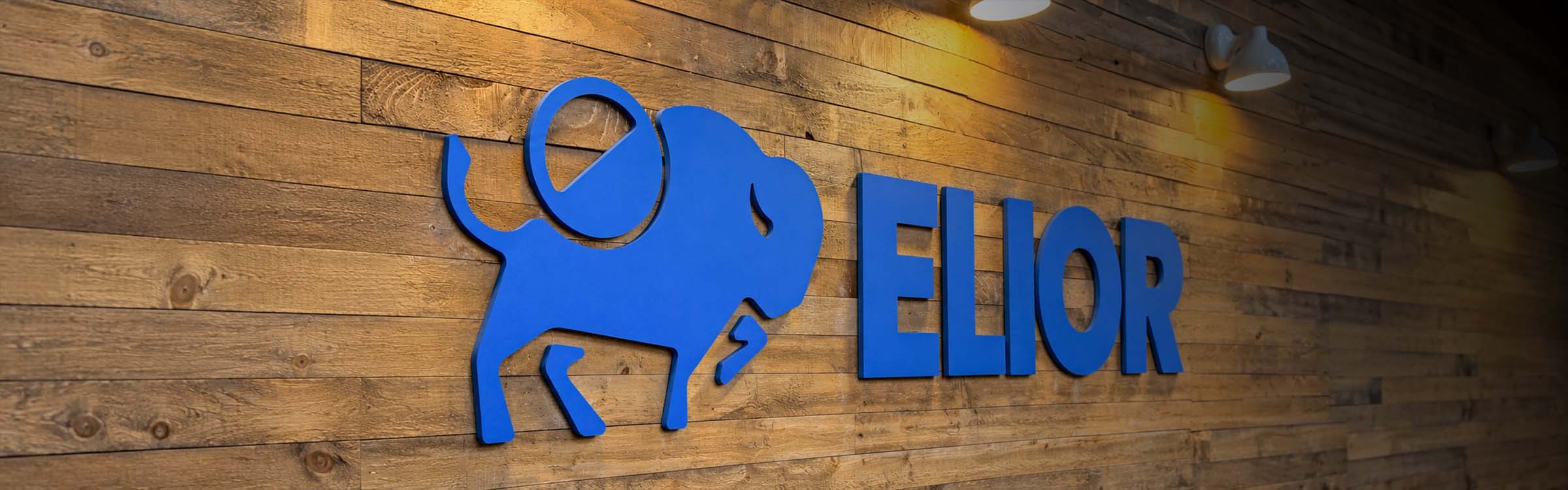 Elior logo on reclaimed wood wall