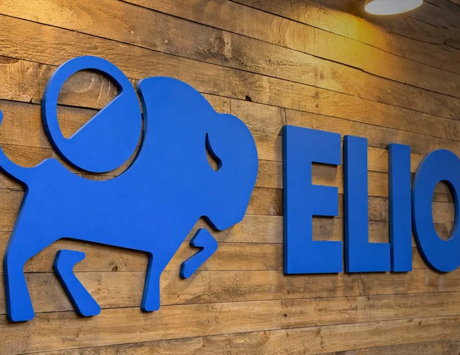 Elior logo on reclaimed wood wall