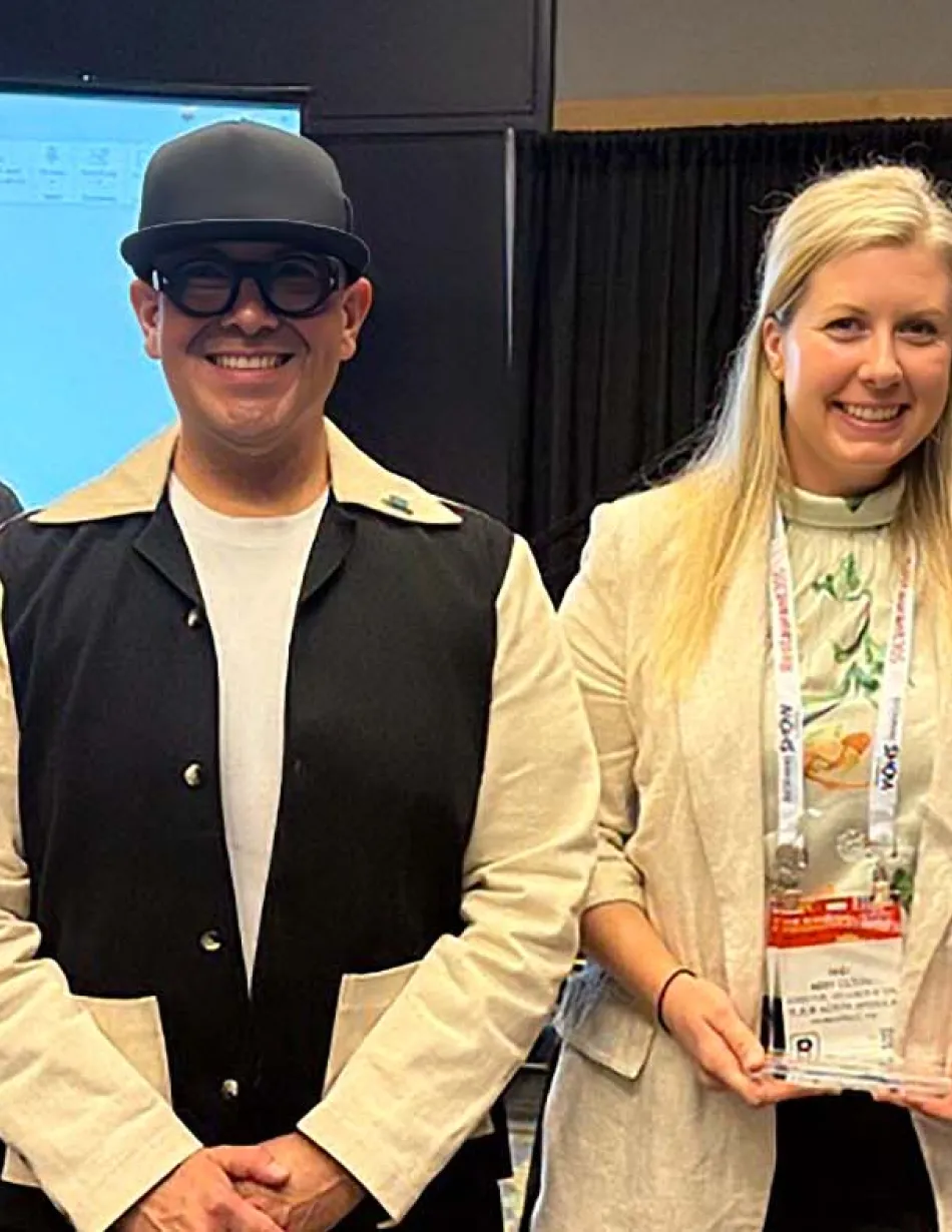 Five Elior North America team members celebrate an industry award at a conference, proudly displaying a recognition trophy and certificate of achievement.