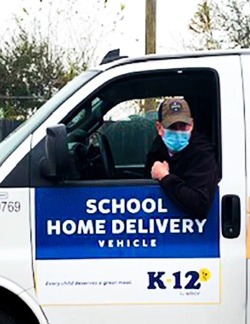 Delivery driver and employee delivering meals