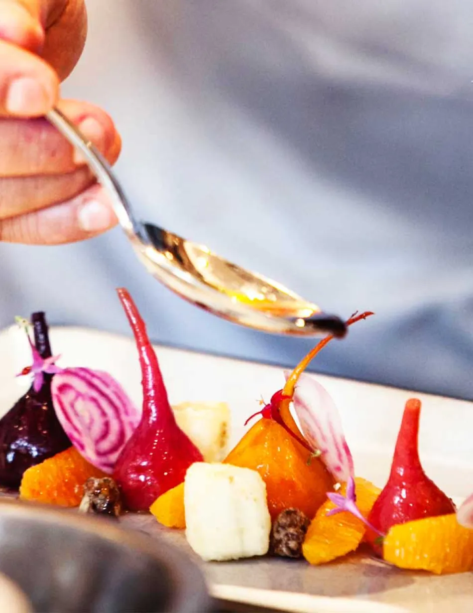 Chef plating dish of roasted beets