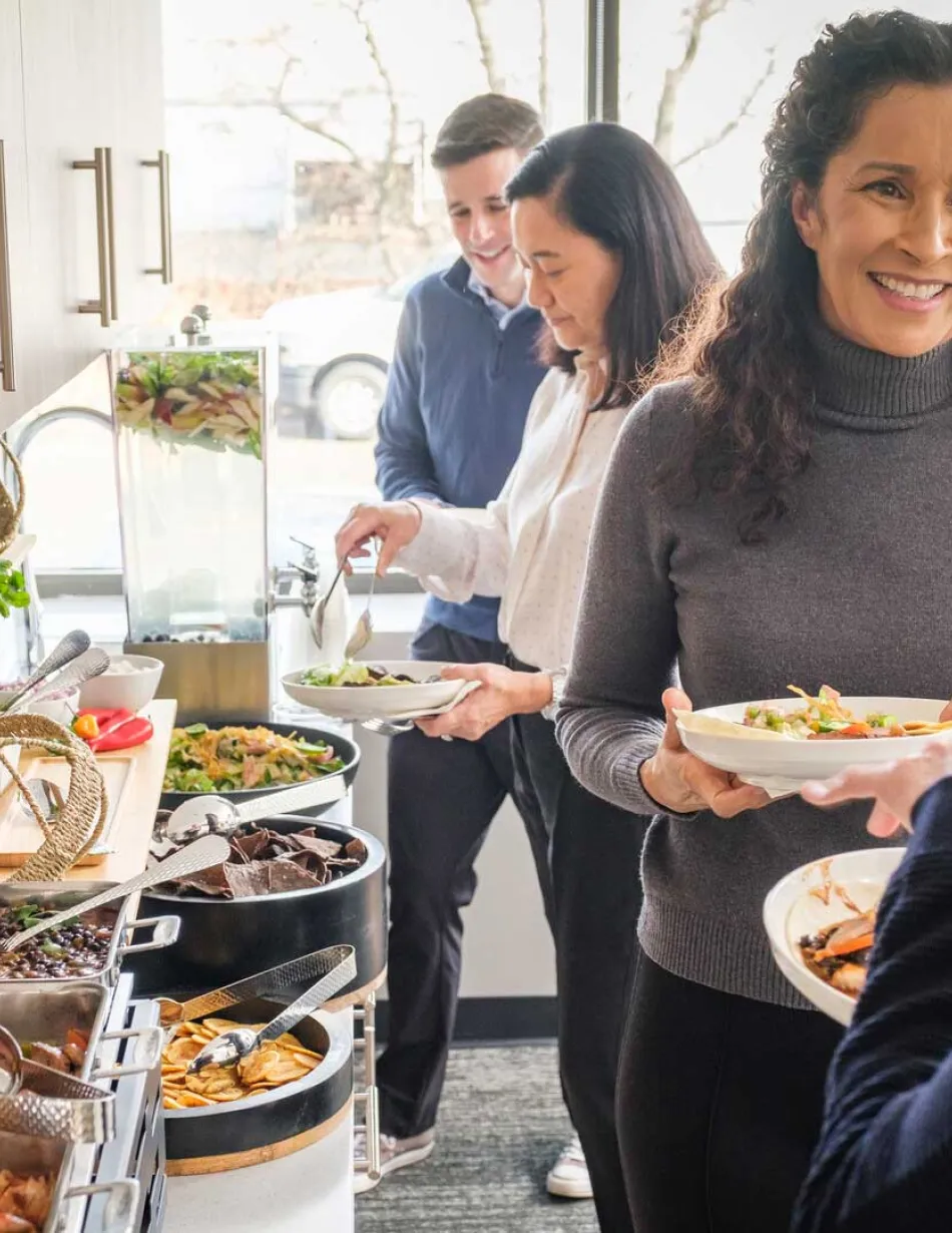 Employees making a plate from buffet