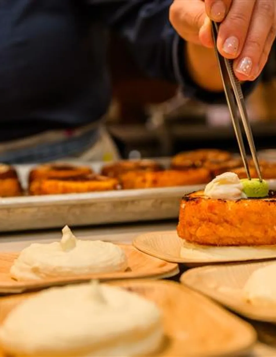 Chef using tweezers to plate an appetizer