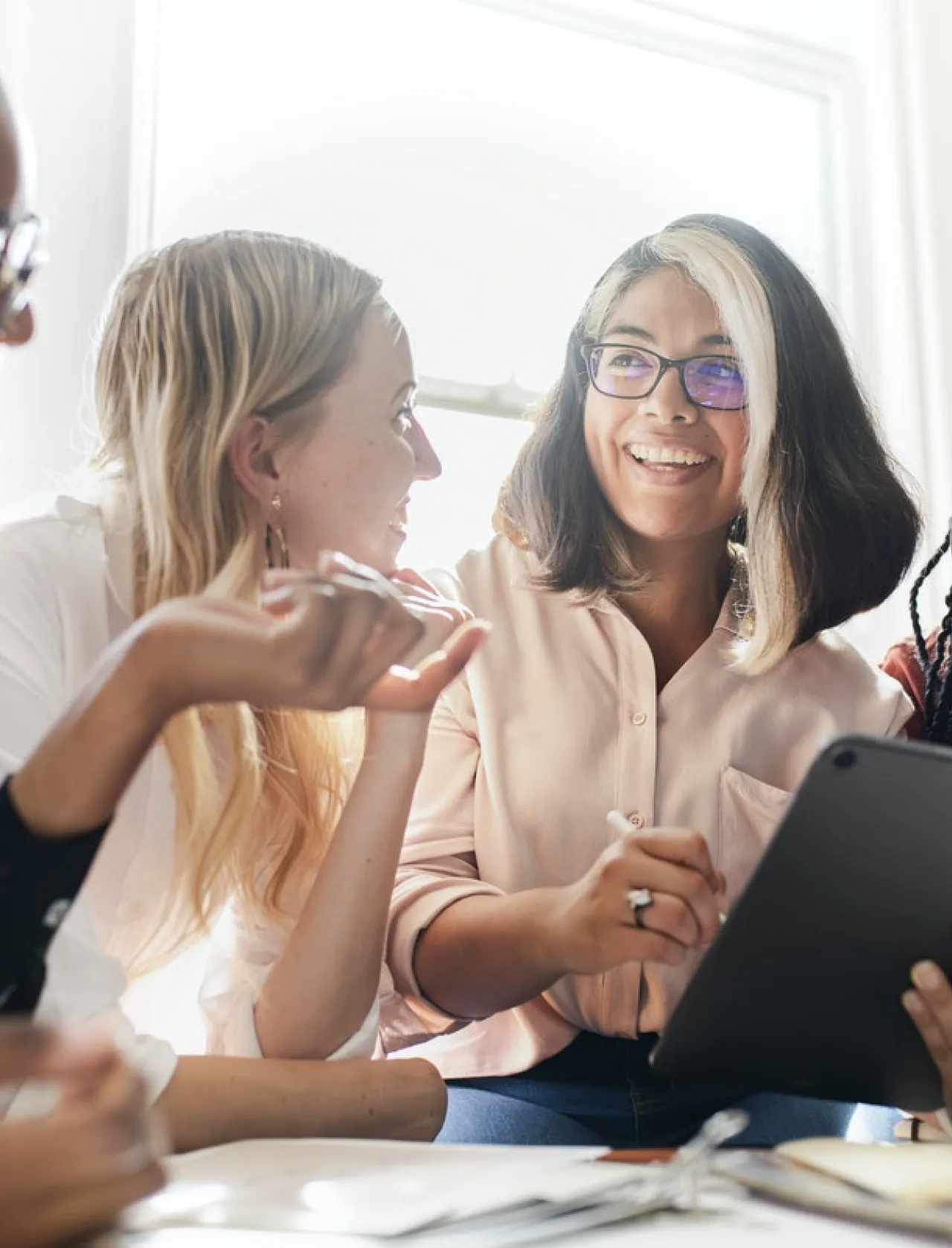 Diverse group of individuals working around a tablet