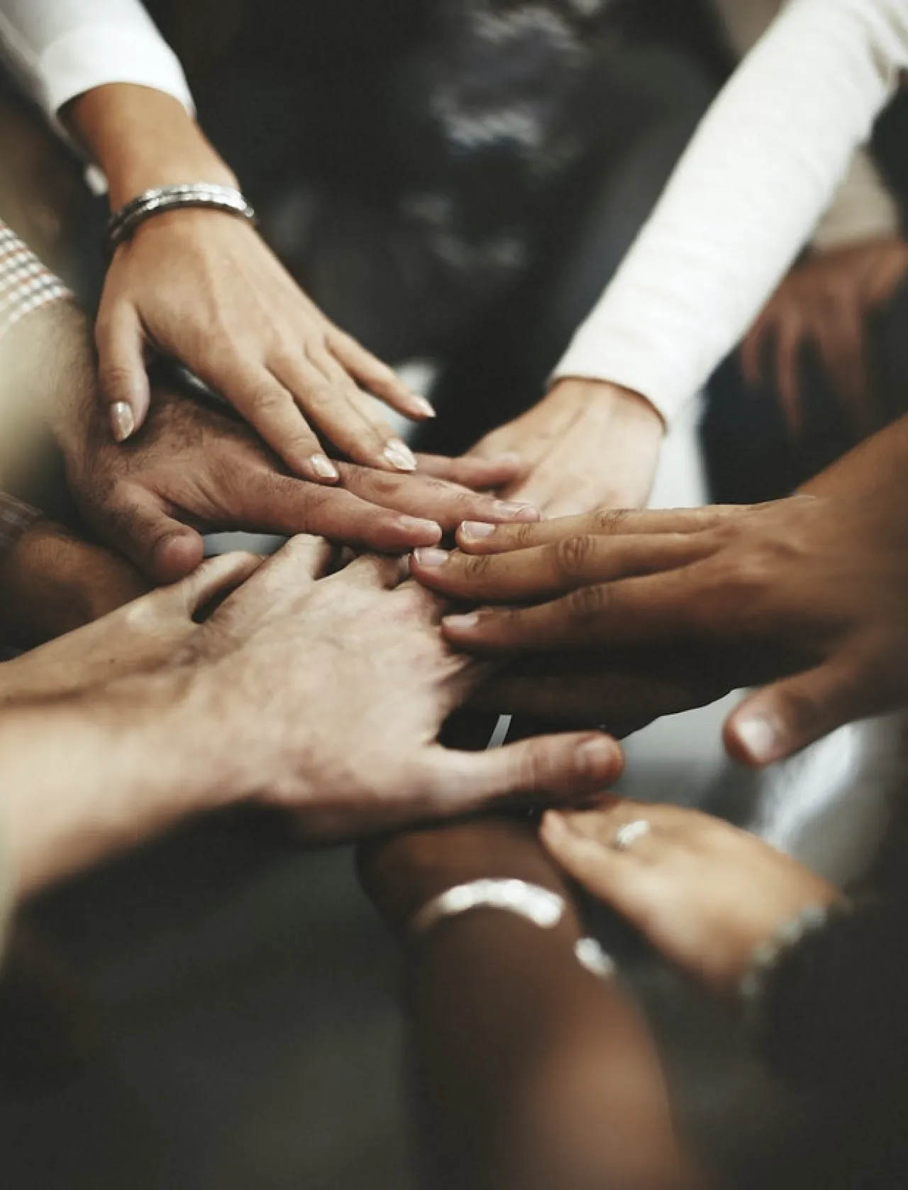Diverse group of hands together in a circle